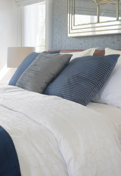 istock Dark color scheme pillows on bed with comfy bedding 817191084