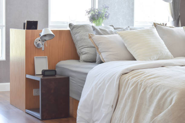 istock stylish bedroom interior design with white striped pillows on bed and decorative table lamp. 817193568