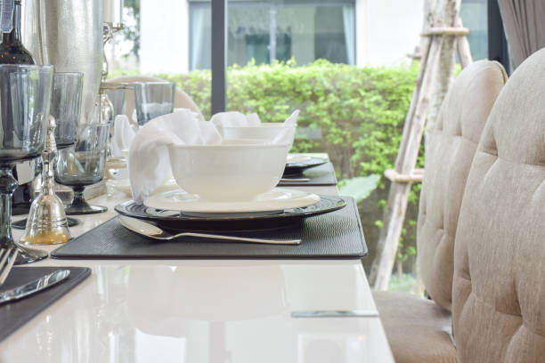 istock dining wooden table and comfortable chairs in modern home with elegant table setting 817193900