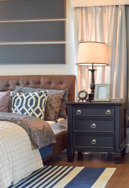 istock Cozy bedroom interior with pillows and reading lamp on bedside table 817197850