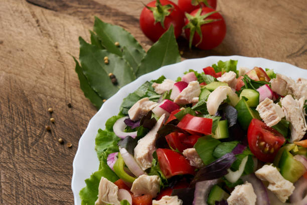 istock Fresh salad from fresh vegetables in a white plate on a wooden table 817198220