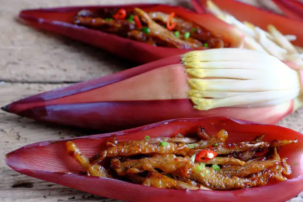 Vegetarian food processing from banana flower, roll young banana fruit with flour then fry and cover with sauce from soy, sugar and chili