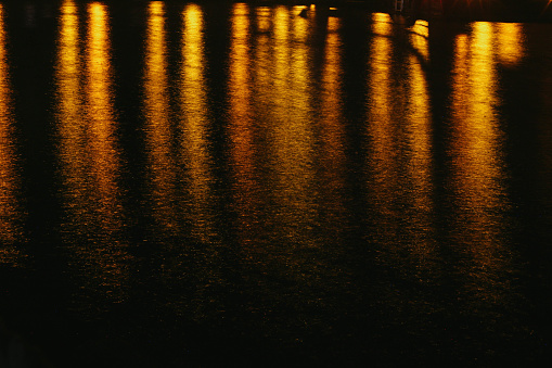 Orange lights reflection off water