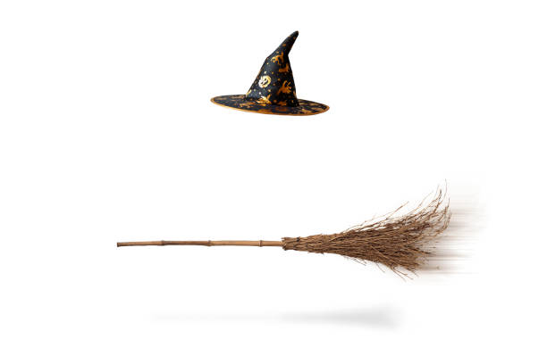 Halloween witch's hat and broom isolated stock photo