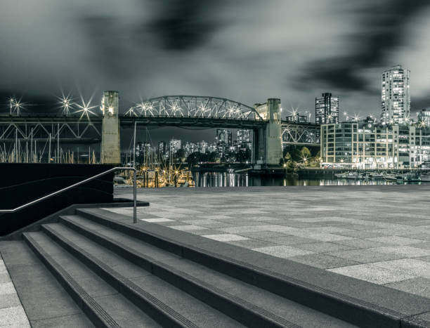 illuminated waterfront skyline and harbor at night,vancouver