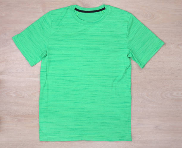 istock Front view green sport tshirt on wooden background 817214148