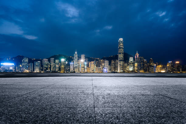 istock empty brick platform with Hong Kong skyline in background at night 817216294