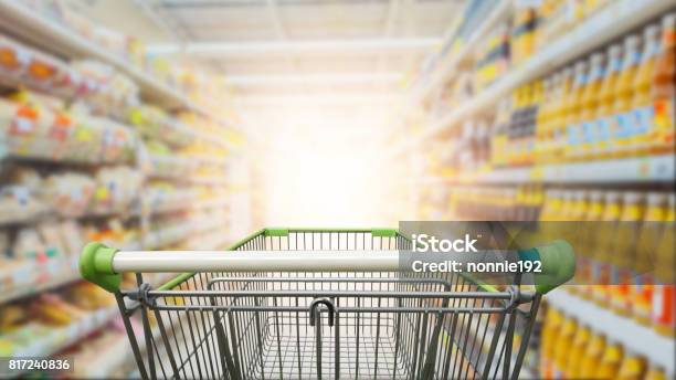 Supermarket Aisle With Empty Green Shopping Cart Stock Photo - Download Image Now - Supermarket, Aisle, Retail