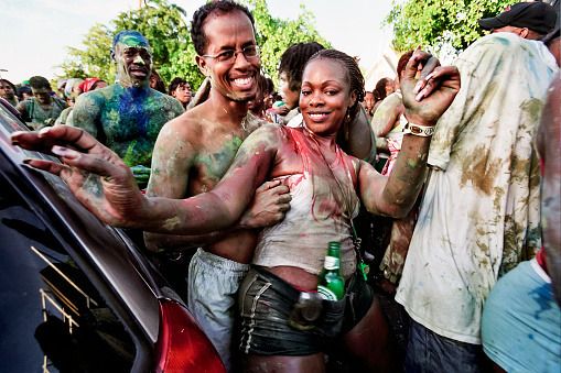Jouvet or “Jour Ouvert” is one of the things that makes Carnival in Trinidad unique. In origin an end of cane harvest rite grafted onto catholic carnival, bands of hundreds of participants covered in mud, paint and beer - dancing, singing and shouting - from 2:00 am till after dawn march around Port of Spain making noise to wake up the rich. Primal, primordial, cathartic. This is a pretty couple working its way through parked cars.