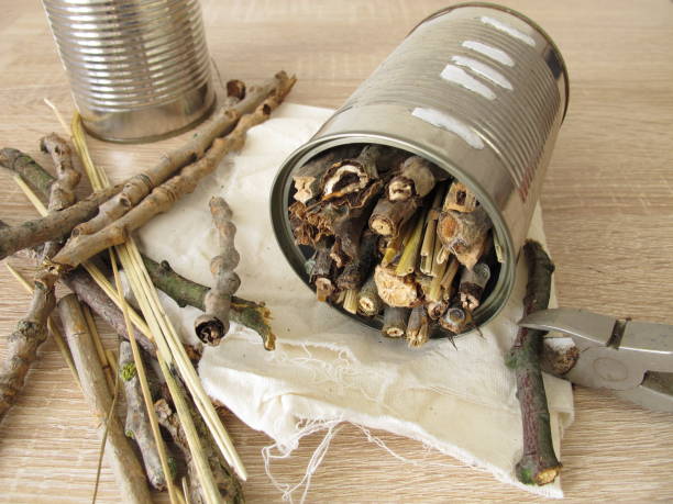 Homemade insect hotel from tin cans, twigs and straw - Self-made insect hotel made of cans, sticks and straw