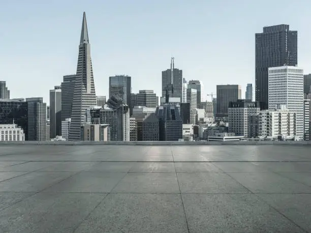 Photo of empty tiled floor front of san francisco downtown skyline with landmark Transamerica Pyramid