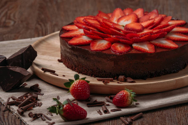 istock Chocolate cake with strawberry on wooden table close-up 817256086