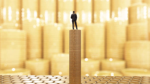 istock Businessman standing on a stack of coins 817263936
