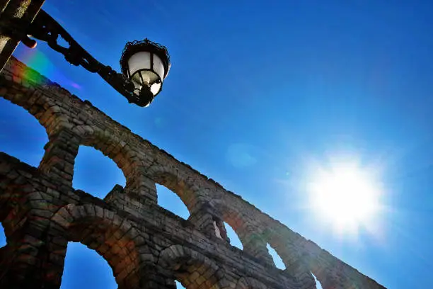 Photo of The Roman Aqueduct of Segovia (The Aqueduct Bridge), one of the best-preserved elevated Roman Aqueducts and the foremost symbol of Segovia as the city's coat of arms, located in Plaza del Azoguejo, Segovia, Spain