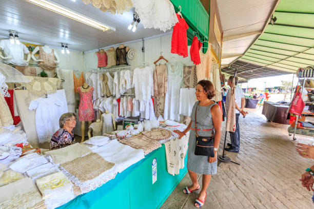 Brasilia, Brazil - February 28, 2017: Working in Brazil businesses theme. Stallholder and customer inside market stall selling souvenirs