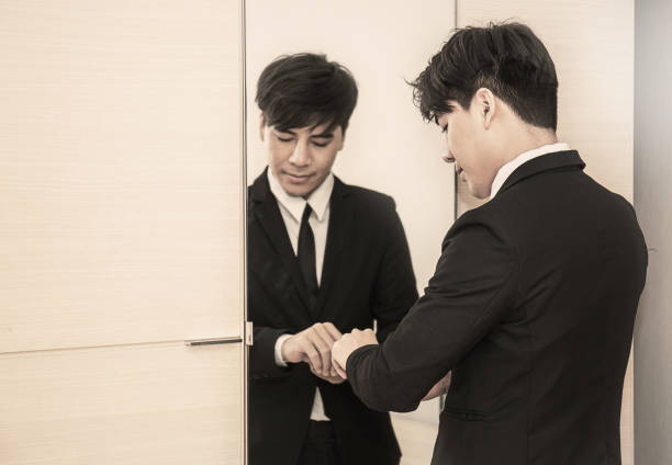 istock Business man dressing up for work in front of the mirror 817274278