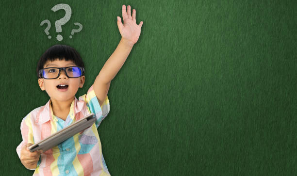 istock boy holding tablet raise his hand up for question asking 817281778