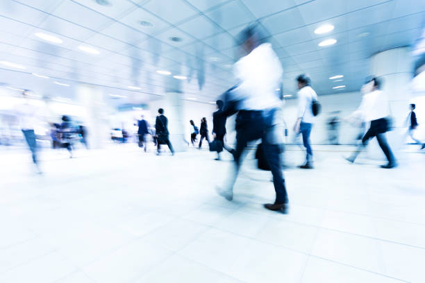 istock Crowds of Commuters Walking Through Modern Underground Pedestrian Walkway in the Morning 817285424