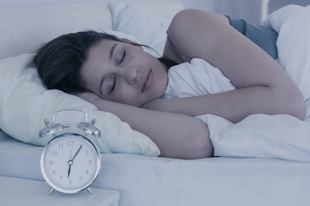 istock Beautiful brunette sleeping in her bed 817290790