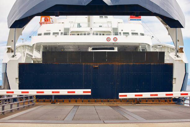 istock Norwegian car ferry landing at port. Closed barrier. 817293436