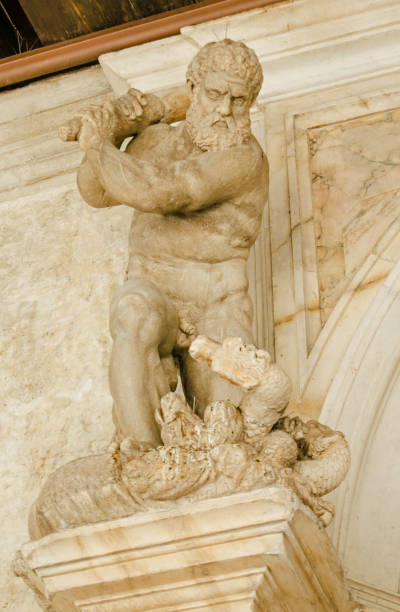 Hercules and the Hydra statue Small statue of Hercules killing the many headed Hydra monster on an exterior wall of the historic Doge's Palace in Venice, Italy. snakes beard stock pictures, royalty-free photos & images