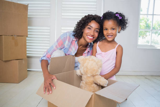 istock Cute daughter unpacking her teddy bear with mother 817298896