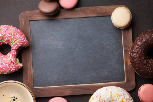 istock Chalkboard, coffee cup and colorful donuts 817301694