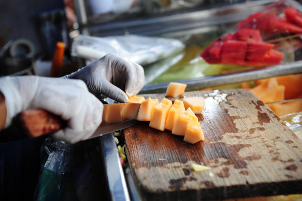 istock Cutting cantaloupe melon on wood board 817302942