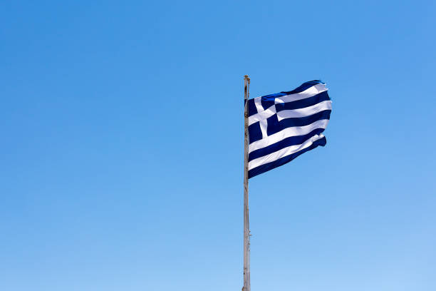istock Flag of Greece against blue sky 817309826