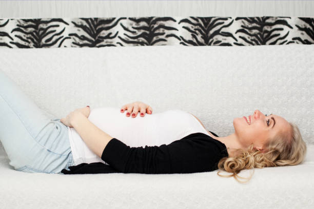 istock pregnant woman is lying on the sofa 817310084