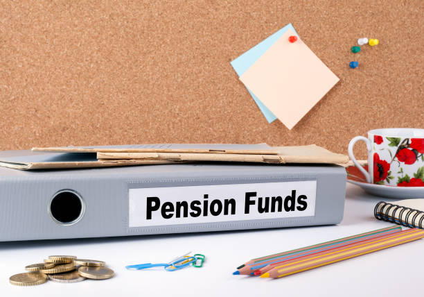 istock Pension Funds. Folder on office desk. Money, Coffee Mug and colo 817310880
