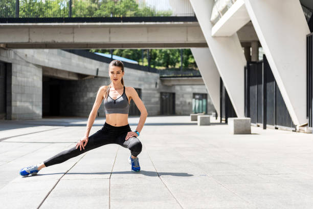 istock Confident girl exercising near stadium 817321734