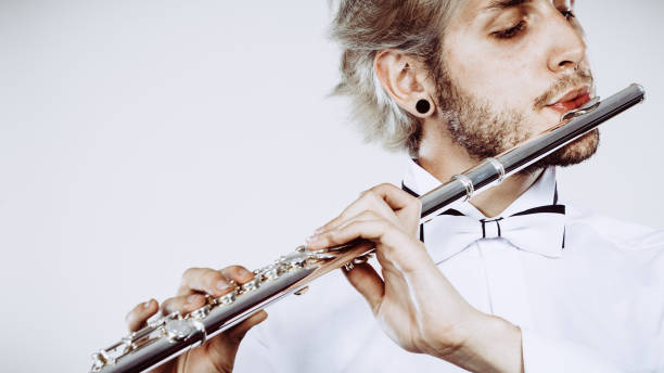 istock Male flutist playing his flute closeup 817325186