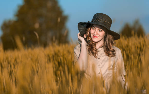 istock Redhead Woman Among Gold Wheat 817328486