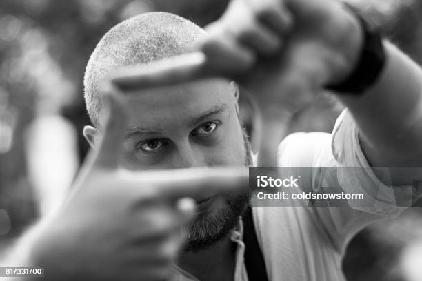 Young Male Photographer Framing A Shot Using His Fingers Stock Photo - Download Image Now