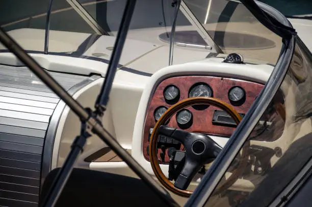 Wooden steering wheel ship on yacht; workplace of the captain yacht.