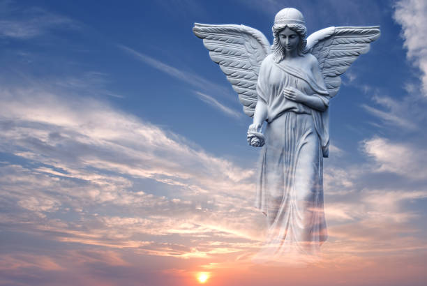 istock Angel in heaven over beautiful sunset 817342386