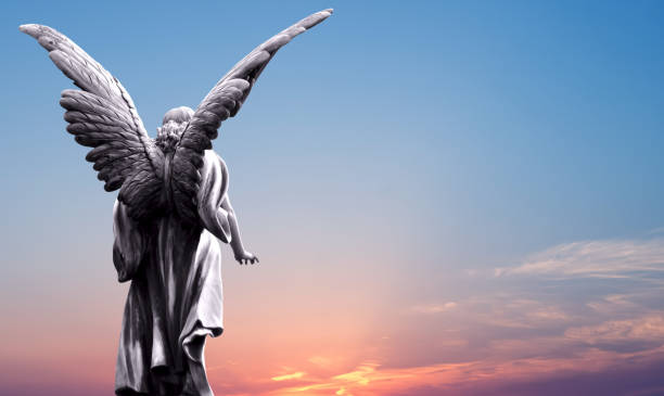 Angel sculpture over bright sky stock photo