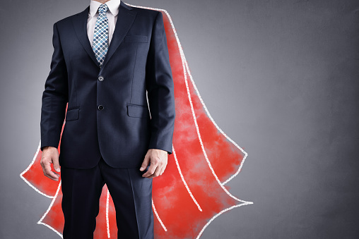 Superhero businessman with red cape drawing on background concept for leadership
