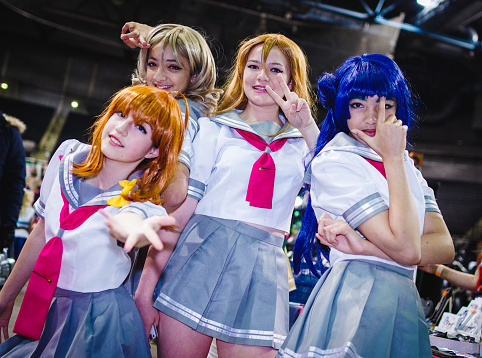 Cosplayers dressed as the idol group 'Aqours' from 'Love Live! Sunshine!!' at the Yorkshire Cosplay Con at Sheffield Arena.