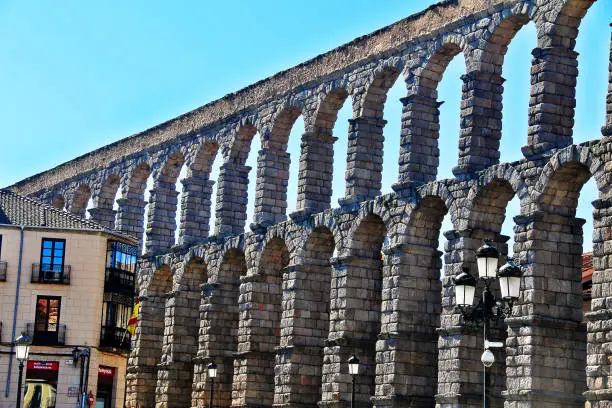 Photo of The Roman Aqueduct of Segovia (The Aqueduct Bridge), one of the best-preserved elevated Roman Aqueducts and the foremost symbol of Segovia as the city's coat of arms, located in Plaza del Azoguejo, Segovia, Spain