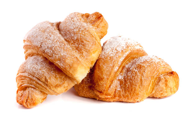 istock two croissant sprinkled with powdered sugar isolated on a white background closeup 817352246