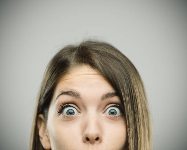 Close-up portrait of surprised beautiful young woman stock photo