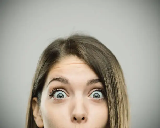 Photo of Close-up portrait of surprised beautiful young woman