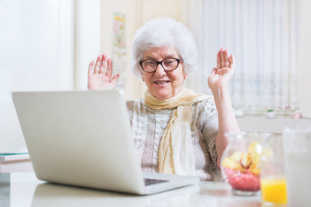 istock Surprised senior woman communicating via instant messaging apps on laptop. 817355134