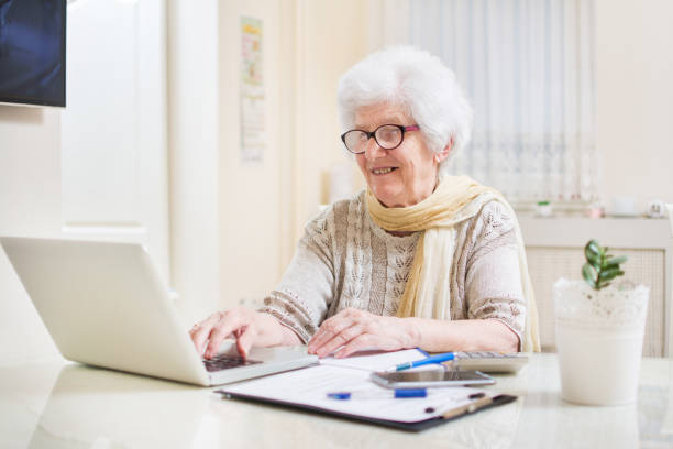 istock Elder woman using a laptop computer at home. 817355136