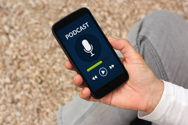istock Hand holding smart phone with podcast concept on screen 817355344