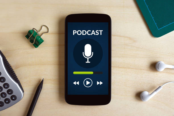 istock Podcast concept on smart phone screen on wooden desk 817355368
