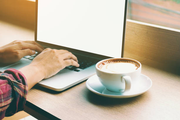 istock Asian young man rear view of hand's pressing keyboard button and thinking for work with coffee in morning on table wooden at cafe. 817355404