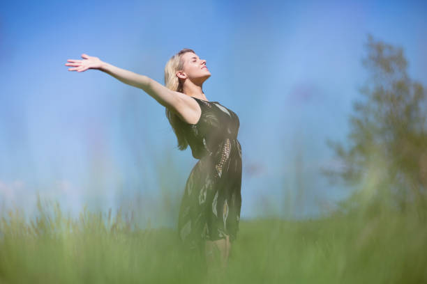 istock Pretty blonde in sundress standing with arms out 817356018